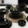 24-piece black stoneware dinner set with gold accents