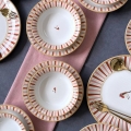 24-piece ceramic dinner set in white, red and gold