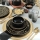 24-piece ceramic dinnerware set in black and gold