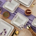 24-piece ceramic dinnerware set in white and purple