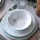 24-piece porcelain dinnerware set in white and green