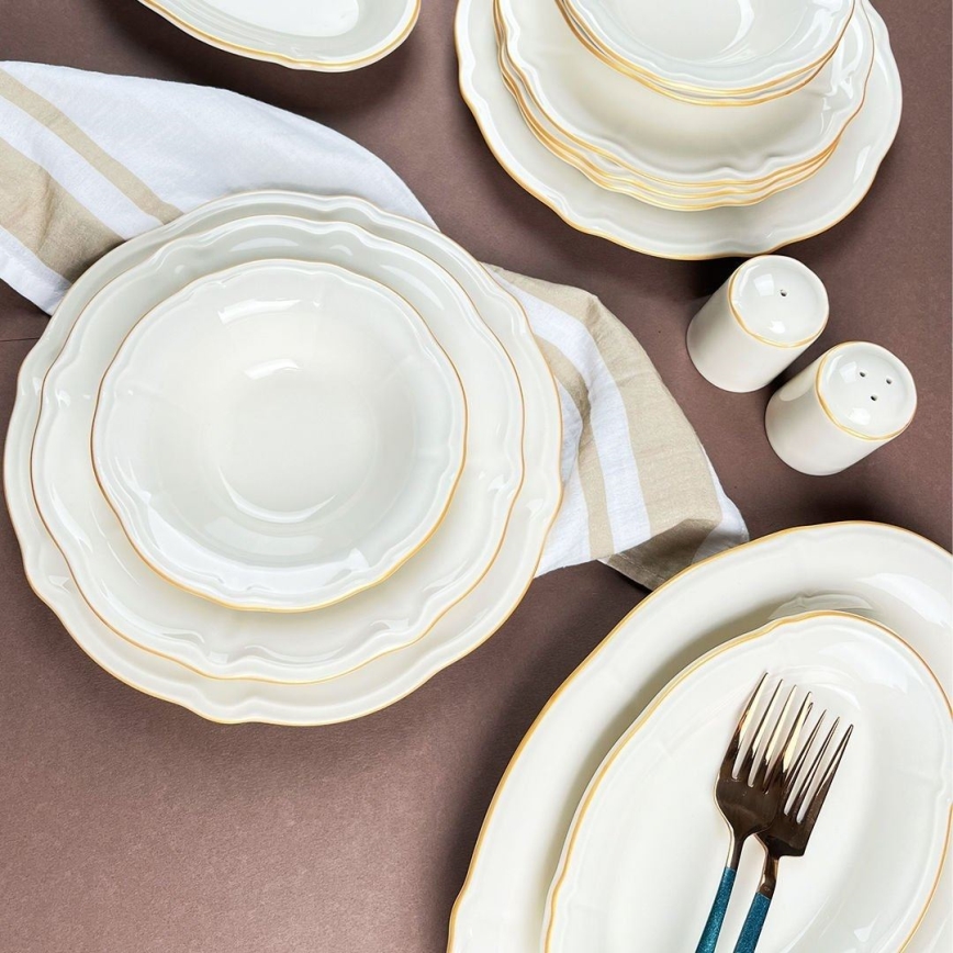 53-piece porcelain dinner set in white with gold accents