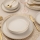 8-piece porcelain dinnerware set in white with gold accents