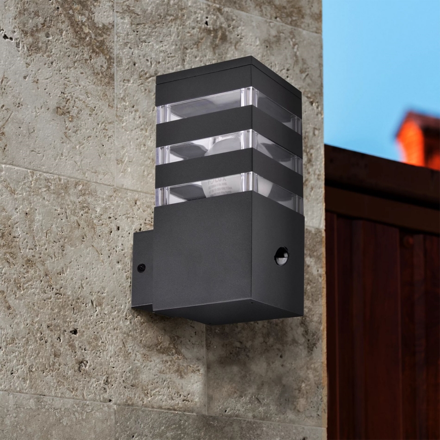 Outdoor wall light with a sensor TEKSAS 1xE27/12W/230V IP44 graphite