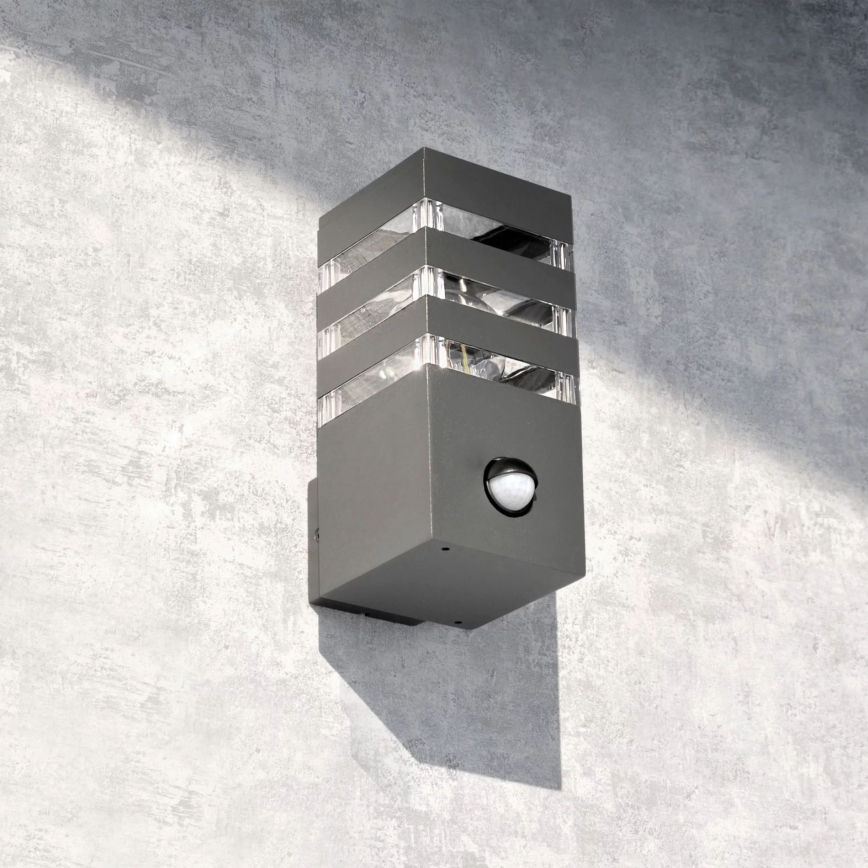 Outdoor wall light with a sensor TEKSAS 1xE27/12W/230V IP44 graphite