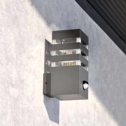 Outdoor wall light with a sensor TEKSAS 1xE27/12W/230V IP44 graphite