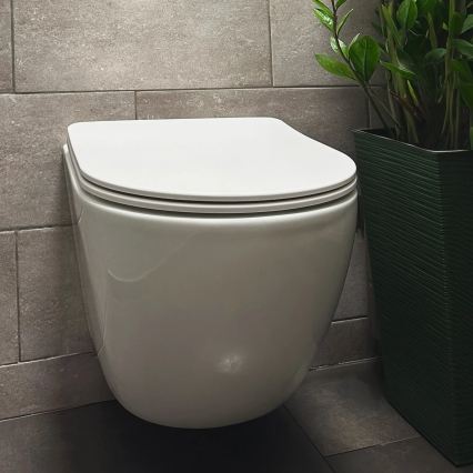 REA-C1259 - Wall-hung toilet with seat CARLO MINI TORNADO RIMLESS ceramic/glossy white